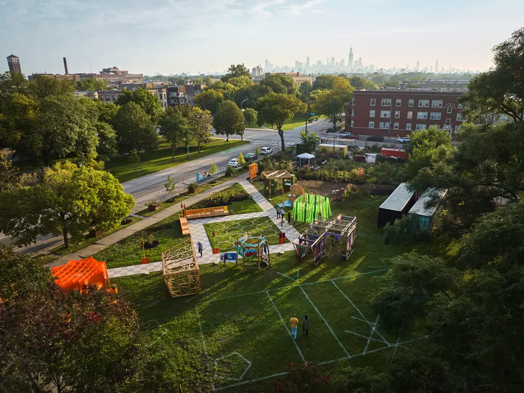 An aerial view of a festival site with green space, paths, and several pavilions.